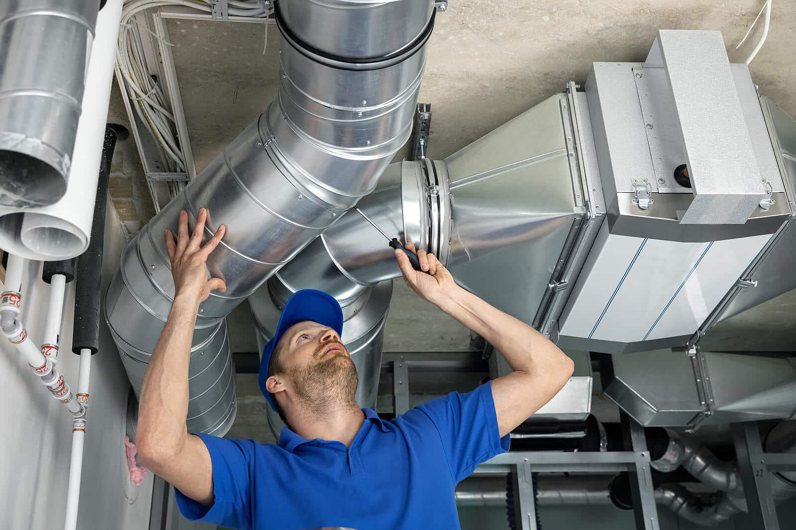 HVAC technician inspecting and repairing air ducts in Livermore