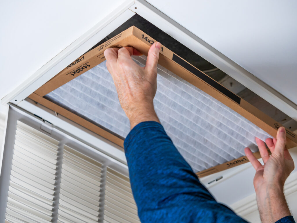 HVAC technician replacing a home air filter in Livermore