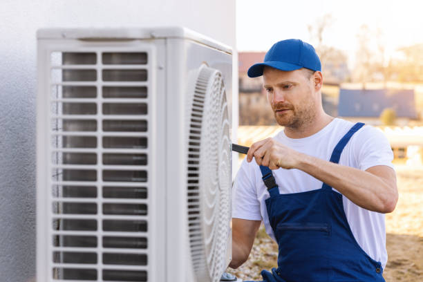 HVAC technician servicing an outdoor air conditioner in Livermore